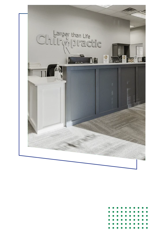 Reception area featuring a front desk, clinic branding, informational displays, and office furnishings.