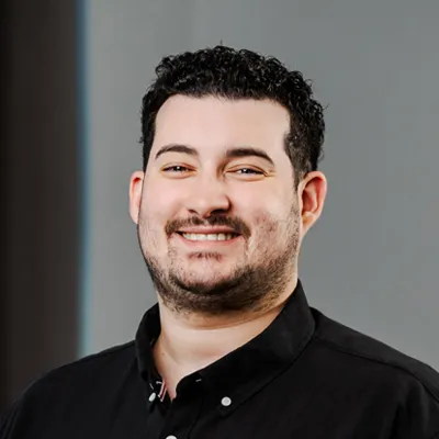 A headshot of Dr. Eduardo Emanuel Rivera, a chiropractor at Larger Than Life Chiropractic.